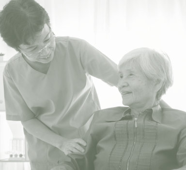 a senior woman being assisted by a caregiver