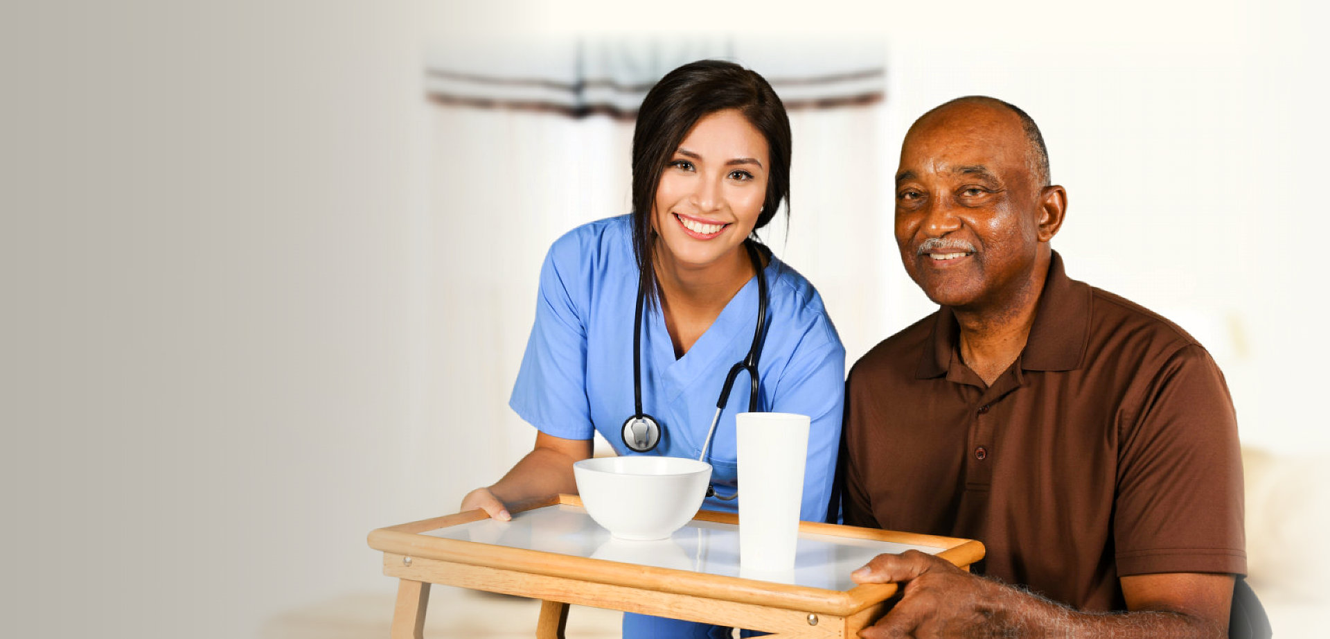 a nurse and a senior man smiling