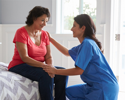 a caregiver comforting a senior woman