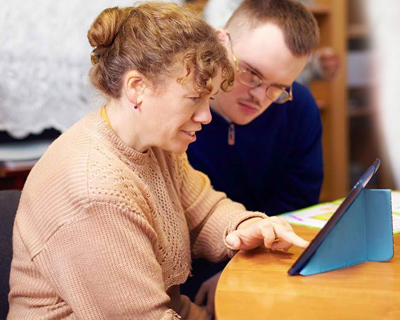 two disabled persons working online