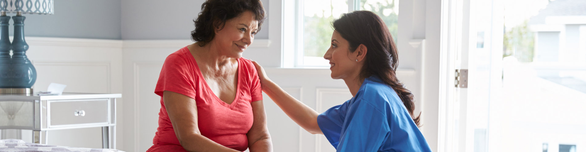 a caregiver comforting a senior woman