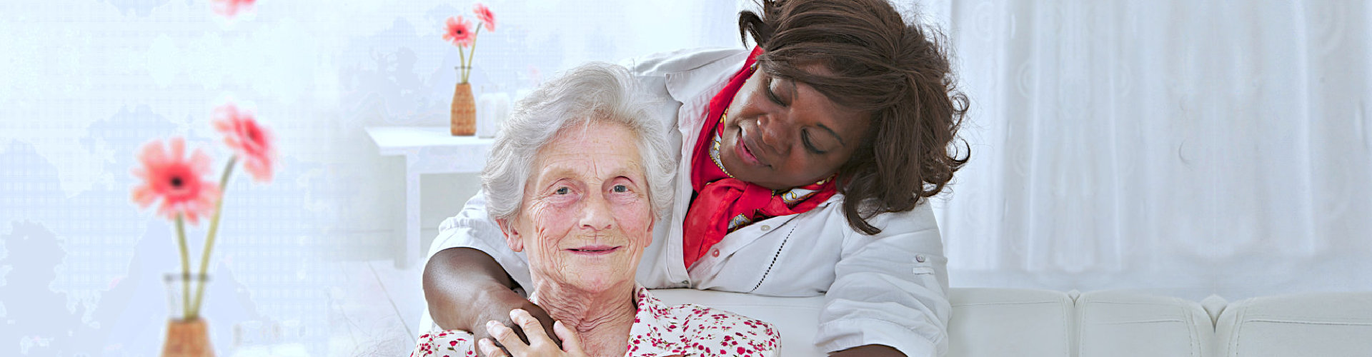 a caregiver and a senior woman smiling