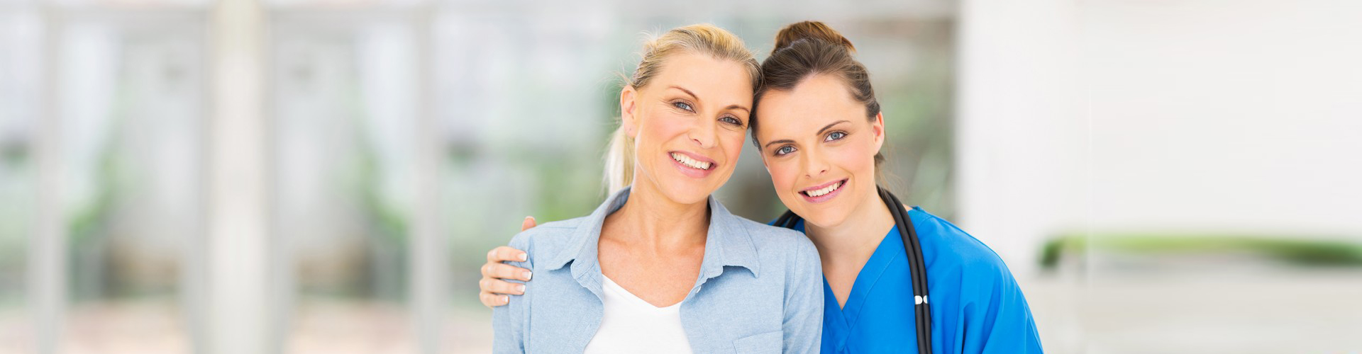 a nurse and a disabled senior woman smiling